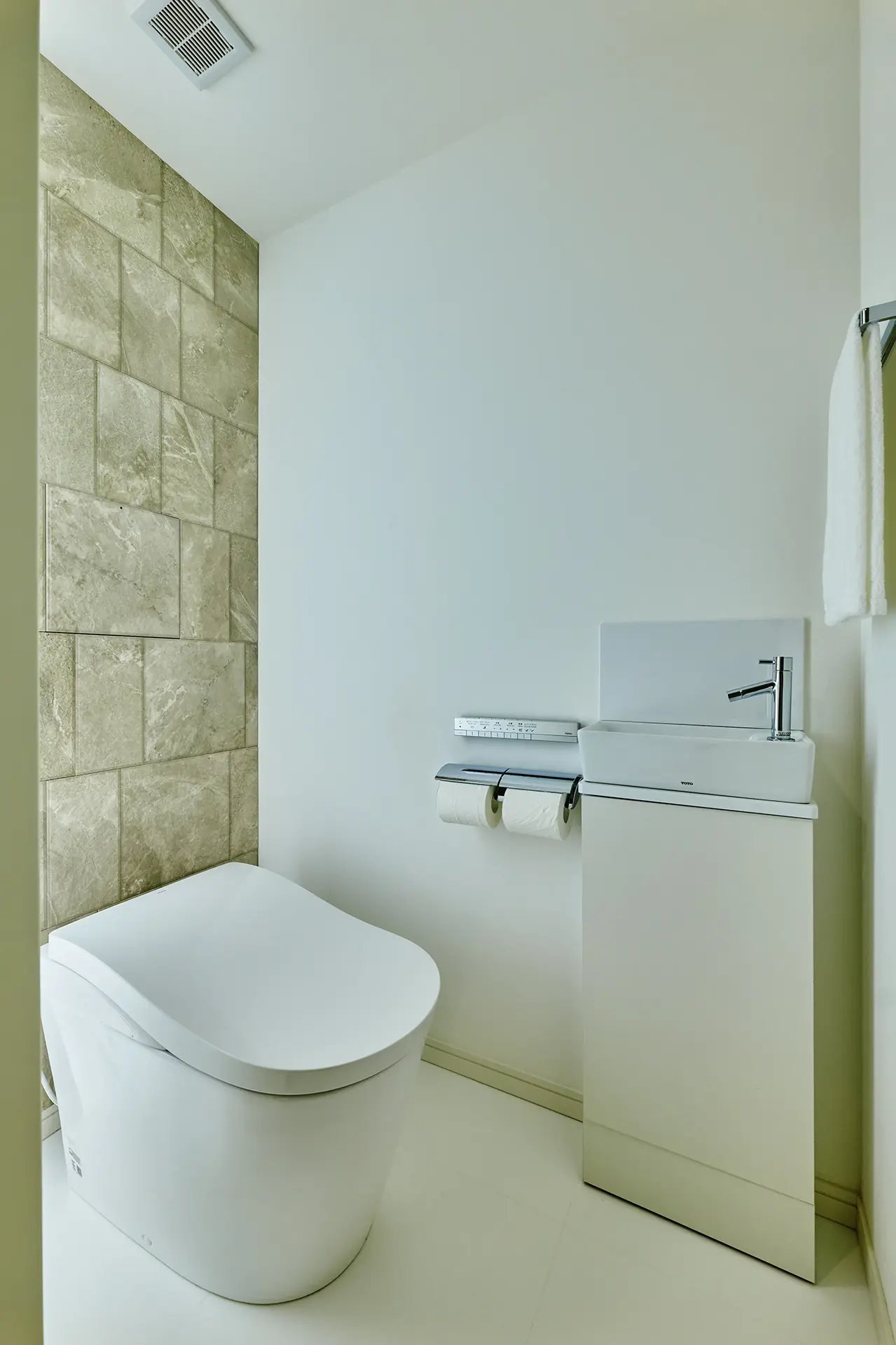 壁面に表情豊かな仕上げを用いたトイレ